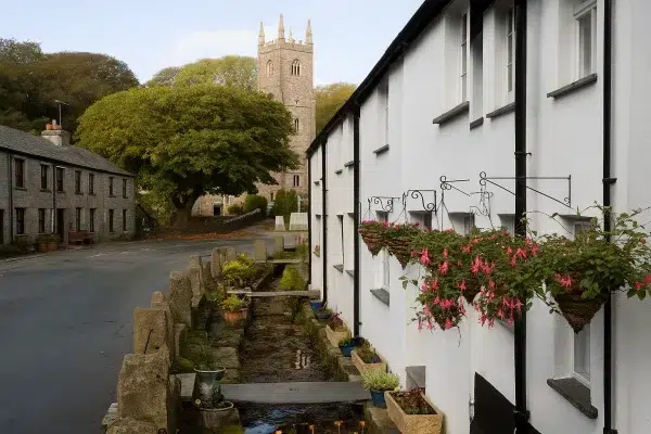 View towards St Nonna’s Church in Altarnun, Cornwall, past Leat Cottages with a historic leat — a manmade watercourse once powering a local mill.