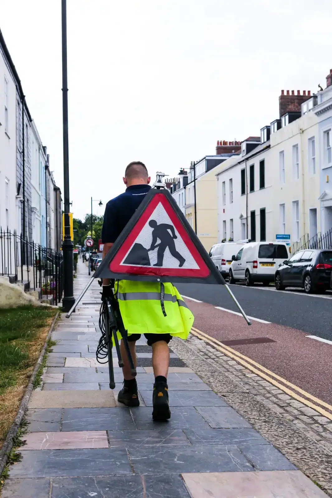 Utility worker inspecting drainage on a Plymouth street